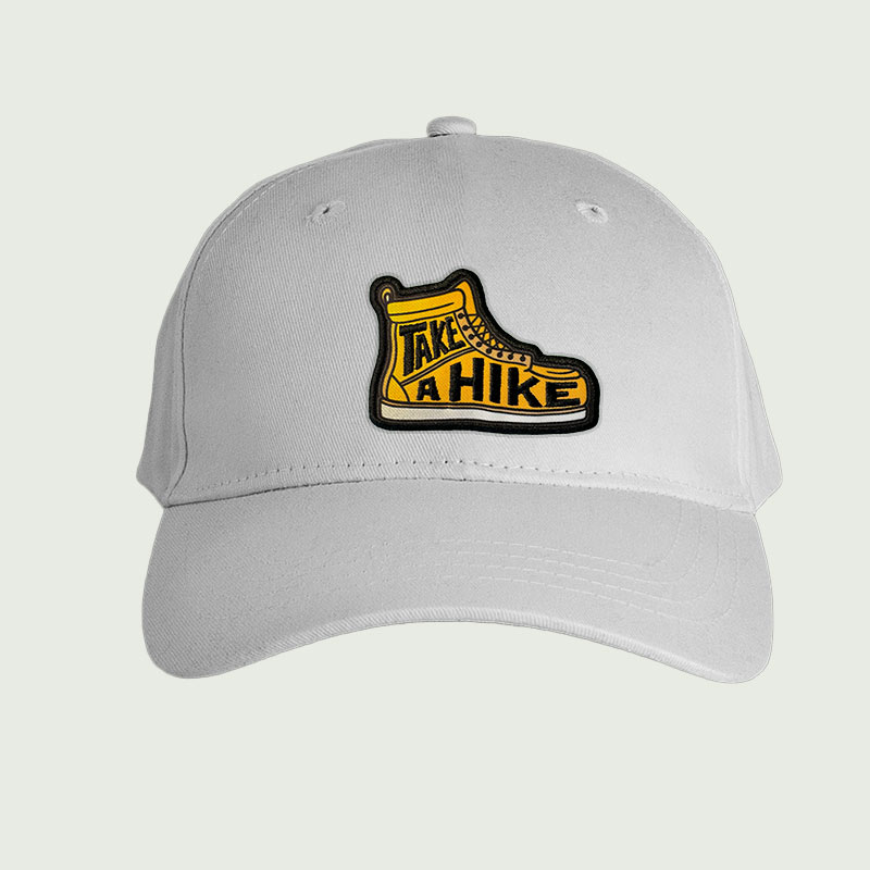 cap-with-hiking-badge-printed-badge-sublimation-badge-embroidery-badge-uk Badge Comparison, woven vs embroidered badges, chenille badges, faux leather badges, combination badges, 3D puff badges, sublimation badges, custom embroidered badges, badge types guide, how to choose custom badges